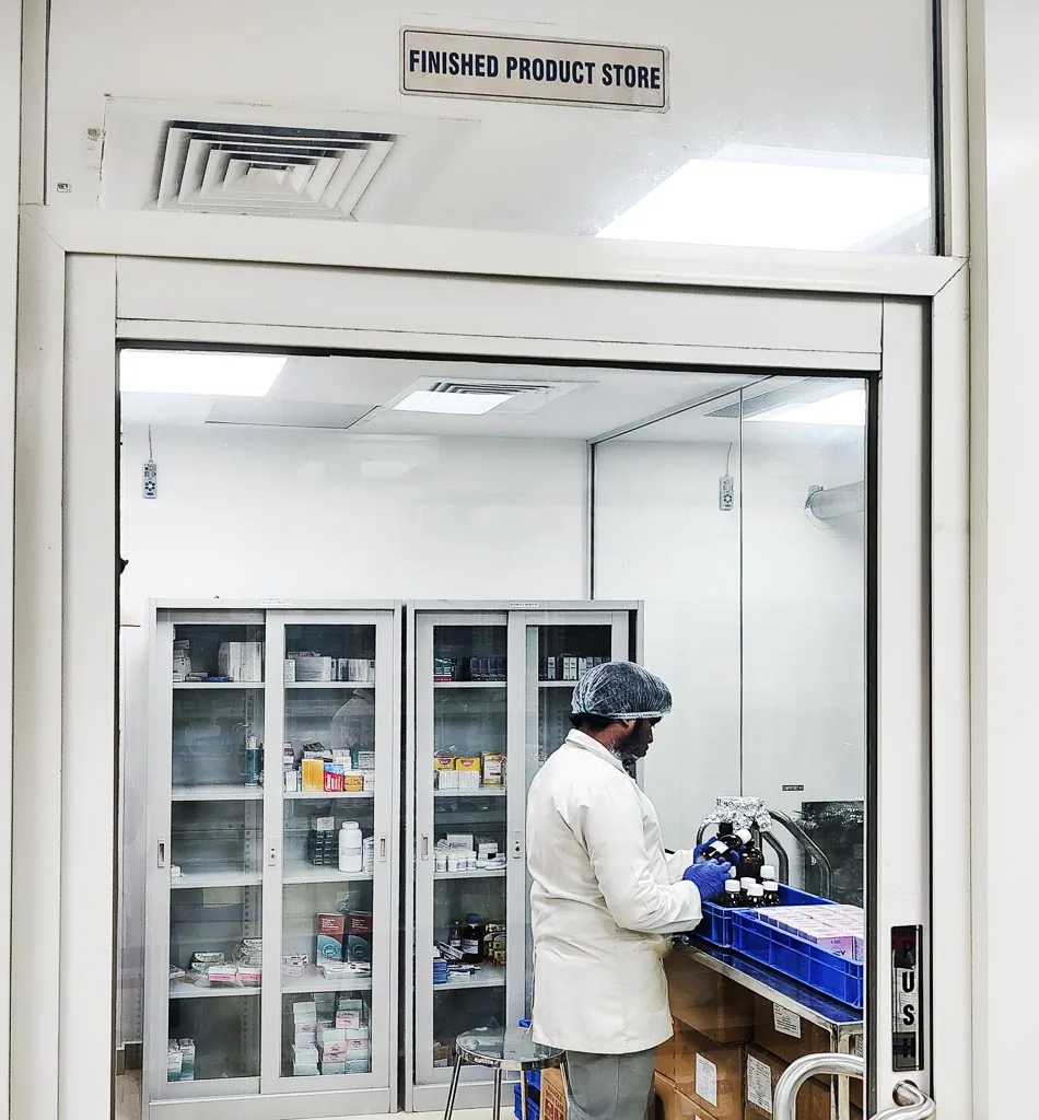 Operator packing finished bottles inside the Stabicon Finished Product Store cleanroom