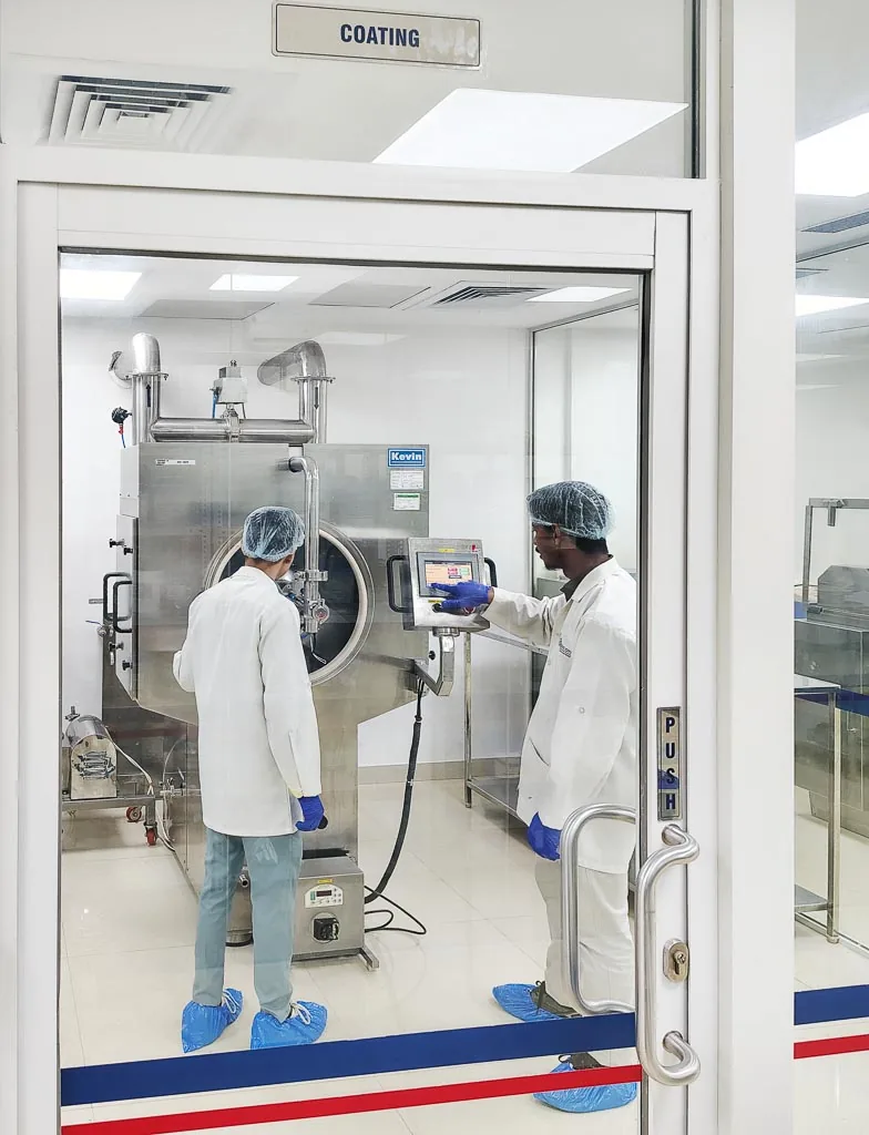 Operators running the tablet coating machine in the Stabicon coating suite