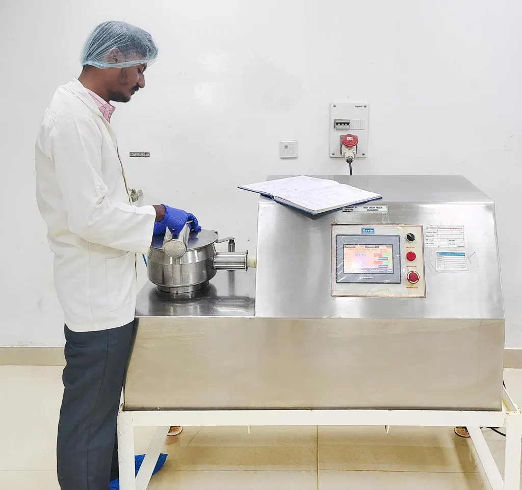 Operator loading the rapid high-shear mixer granulator in the Stabicon granulation suite