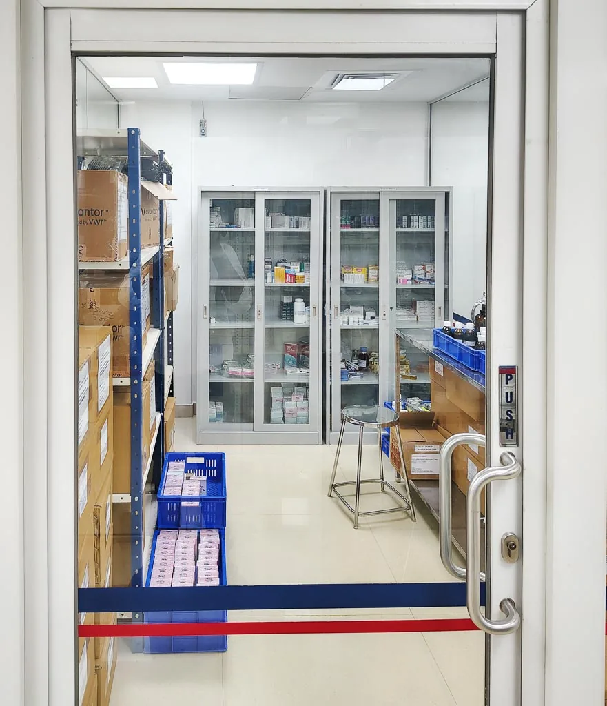 Stabicon sample and reference material store with shelved cartons and glass cabinets, viewed through the entry door