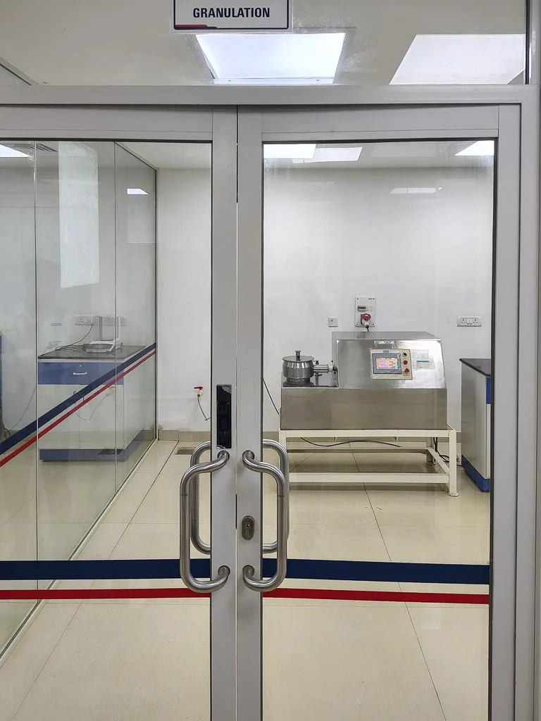 Stabicon granulation cleanroom with a rapid mixer granulator, viewed through the glass double doors