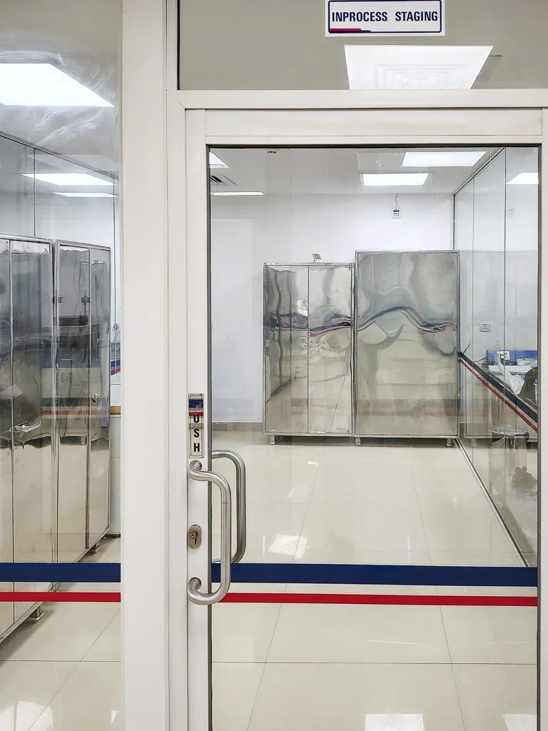 Stabicon in-process staging area with stainless-steel storage cabinets viewed through the door